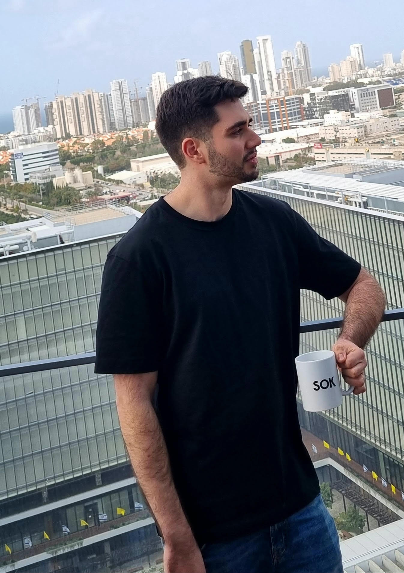 Founder standing on a balcony with a city skyline in the background
